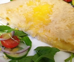 Na zdjęciu talerz, na nim potrawa Chaczapuri podana z warzywami